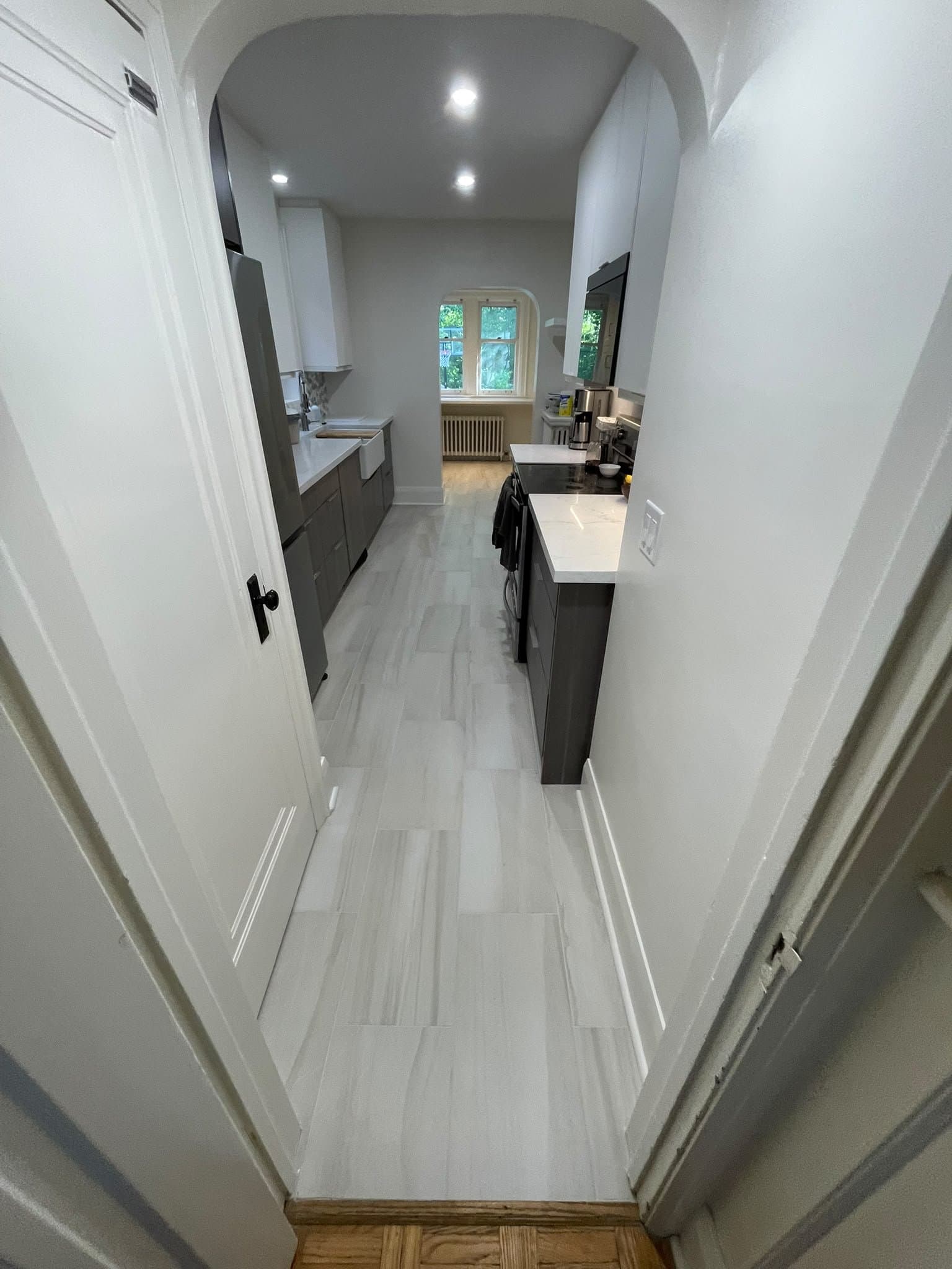 Galley kitchen renovation with new tile flooring