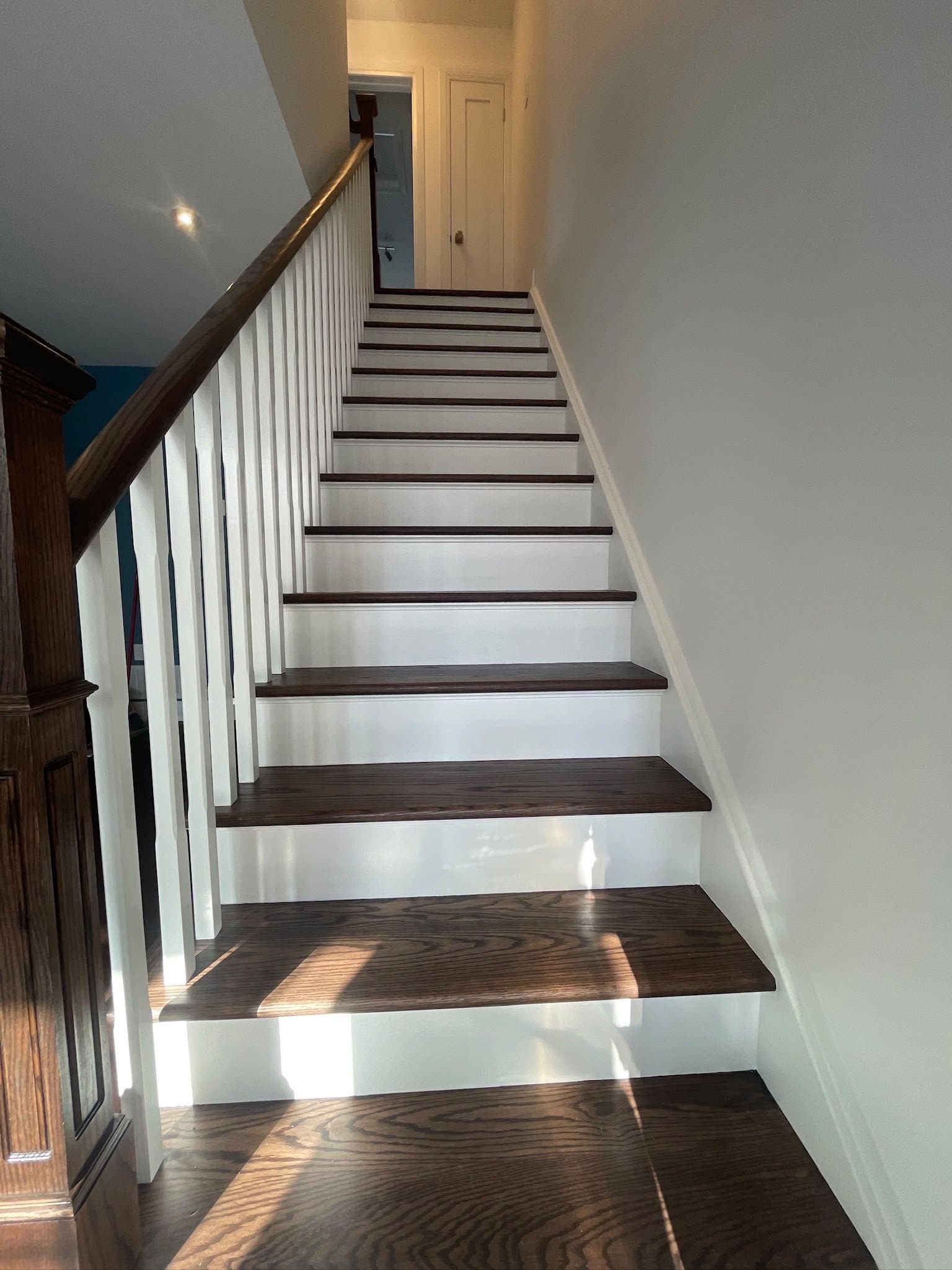 Renovated staircase with white risers and stained treads