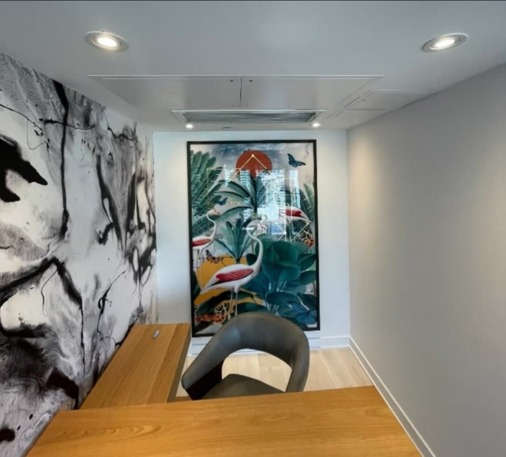 Finished home office with statement wallpaper and framed art
